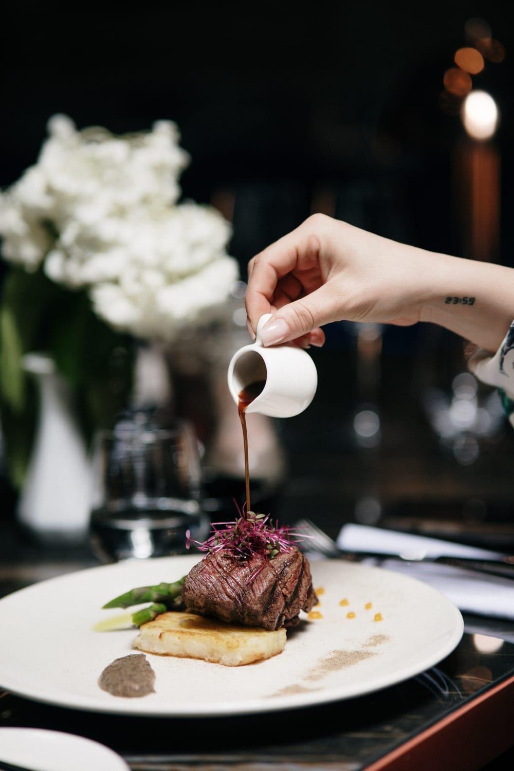 Xheko Imperial Luxury Hotel & Spa Tirana Exterior photo A server pours soy sauce onto a dish